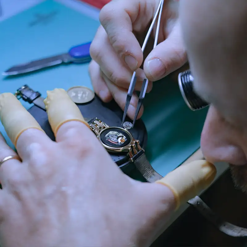 Watchmaker Adjusting the Mechanism of a Quartz Watch