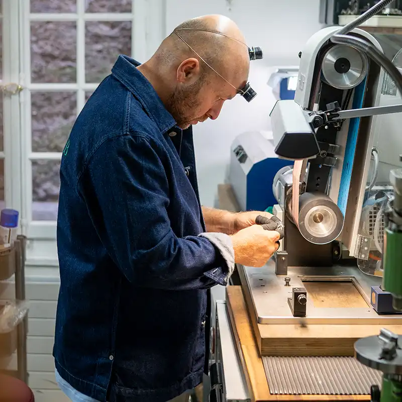 Watchmaker in The Watch Lab Genève workshop performing watch polishing